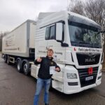 HGV student passed with certificate in front of truck
